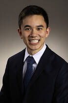 Vinh Le, MD, an Asian man, smiles for a headshot while wearing a black suit.