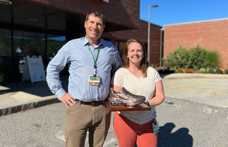 James Suozzi, DO, NRP, FACEP, and Ashley DeLea, MS, ATC, N.H.LAT, hold the award outside of Cheshire's Emergency Department