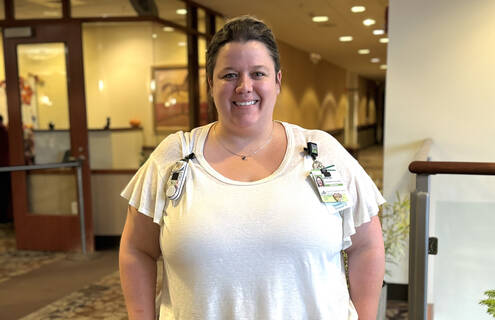 Kristen Nadeau, a white woman, poses for a photo in Cheshire Medical Center's main lobby