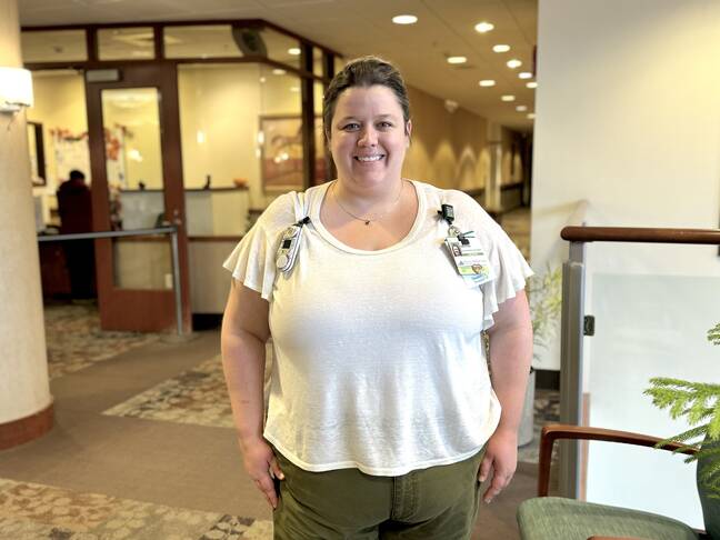 Kristen Nadeau, a white woman, poses for a photo in Cheshire Medical Center's main lobby